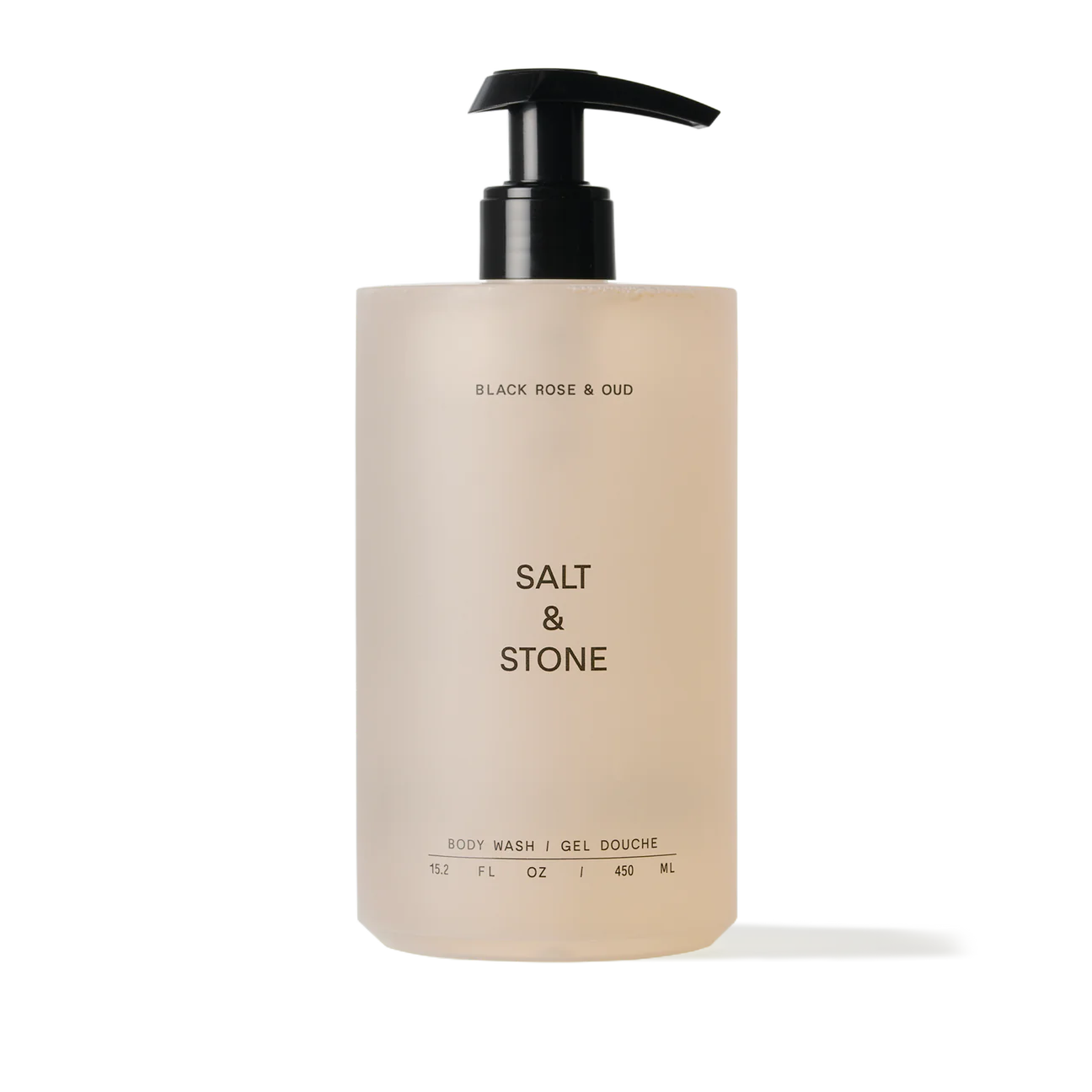 A pump bottle of salt & stone body wash with a beige label against a neutral background.