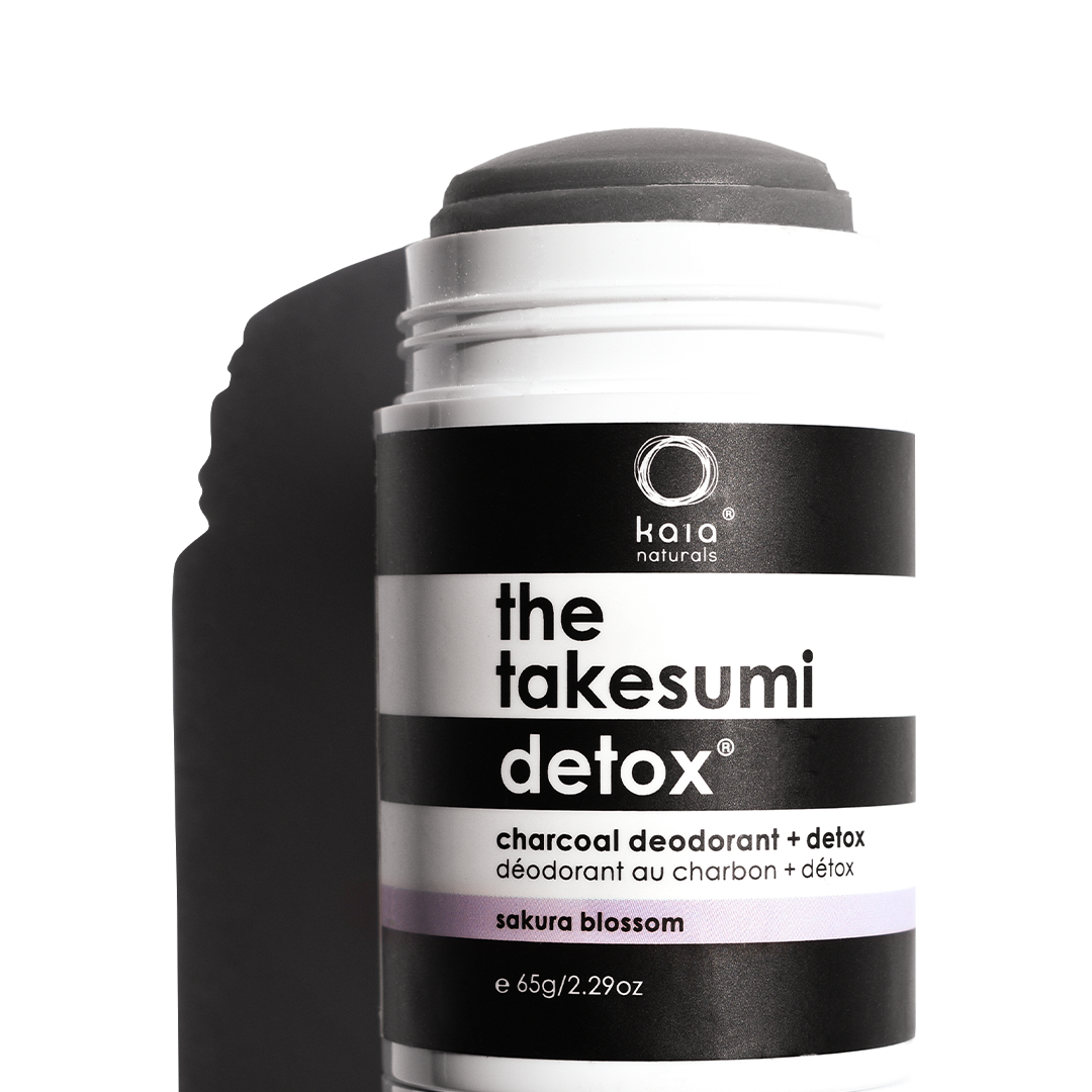 A container of kaia naturals charcoal deodorant with sakura blossom scent.